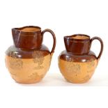 A GRADUATED PAIR OF DATED SALTGLAZED BROWN STONEWARE HUNTING JUGS IMPRESSED ON THE SHOULDER W.R.