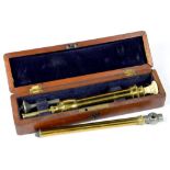 A VICTORIAN LACQUERED BRASS ENEMA SYRINGE WITH TURNED IVORY PLUNGER, FITTED MAHOGANY CASE (HINGE