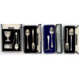 THREE CASED SILVER CHRISTENING SPOON SETS AND AN EGGCUP, SPOON AND NAPKIN RING, WITH A PAIR OF