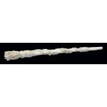A VICTORIAN IVORY PARASOL HANDLE CARVED WITH SPIRALLING BANDS OF ROSES AND OTHER FLOWERS AND