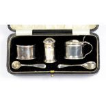 A GEORGE V SILVER THREE PIECE CONDIMENT SET OF CYLINDRICAL FORM, BLUE GLASS LINERS, PEPPER CASTER