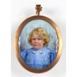 ENGLISH SCHOOL, CIRCA 1910, PORTRAIT MINIATURE OF A YOUNG GIRL IN A BLUE SMOCK, IVORY, OVAL, 5.5CM X