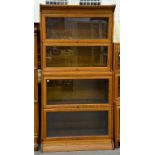 AN OAK GLOBE WERNICKE STYLE FOUR SECTION BOOK CASE, 171 X 87 X 43CM