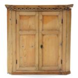 A VICTORIAN PINE BARREL BACKED WALL MOUNTED CORNER CUPBOARD WITH PANELLED DOORS, 96 X 92CM