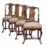 A SET OF FOUR NORTHERN EUROPEAN WALNUT SPOON BACK DINING CHAIRS, 18TH C carved with a shell to the