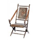 A VICTORIAN FAUX BAMBOO AND EMBOSSED AND SILVERED LEATHER FOLDING CHAIR, C1890 100cm h ++In good