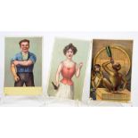 THREE LATE 19TH CENTURY CHROMOLITHOGRAPH NOVELTY POSTCARDS OF A WOMAN IN A CORSET BRANDISHING A