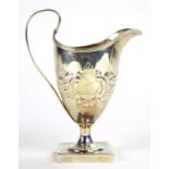 A GEORGE III SILVER HELMET SHAPED CREAM JUG ON SQUARE FOOT, LATER CHASED, 14CM H, BY PETER AND ANN