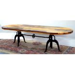 A LARGE DINING TABLE WITH RECLAIMED TIMBER TOP ON AN INDUSTRIAL STYLE CAST IRON BASE, 280CM X 111CM