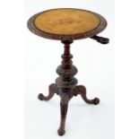 A VICTORIAN CARVED WALNUT TRIPOD TAB LE WITH INLAID TOP, 73CM H