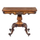 A VICTORIAN MAHOGANY TEA TABLE the quarter veneered fold-over top with shell and scroll carved