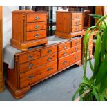 A STAINED PINE BEDROOM SUITE COMPRISING OF A WARDROBE, DRESSING TABLE AN STOOL, CHEST OF DRAWERS AND