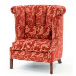 A BARREL BACK ARMCHAIR UPHOLSTERED IN RED FABRIC