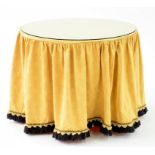 A MODERN TRIPOD TABLE BASE COVERED IN GOLD FABRIC WITH GLASS TOP