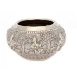 A BURMESE SILVER REPOUSSÉ BOWL, LATE 19TH C chased in high relief with figures and trees on a