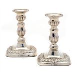 A PAIR OF EDWARD VII GADROONED SILVER CANDLESTICKS with nozzles, 17.5cm h, by Horace Woodward & Co