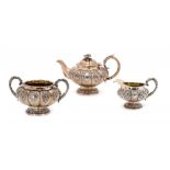 A WILLIAM IV SILVER MELON SHAPED TEA SERVICE crisply chased, the teapot with flower knop, 16.5cm