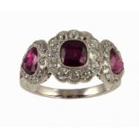 A RUBY AND DIAMOND RING of oblong and heart shaped clusters with calibre cut rubies to the