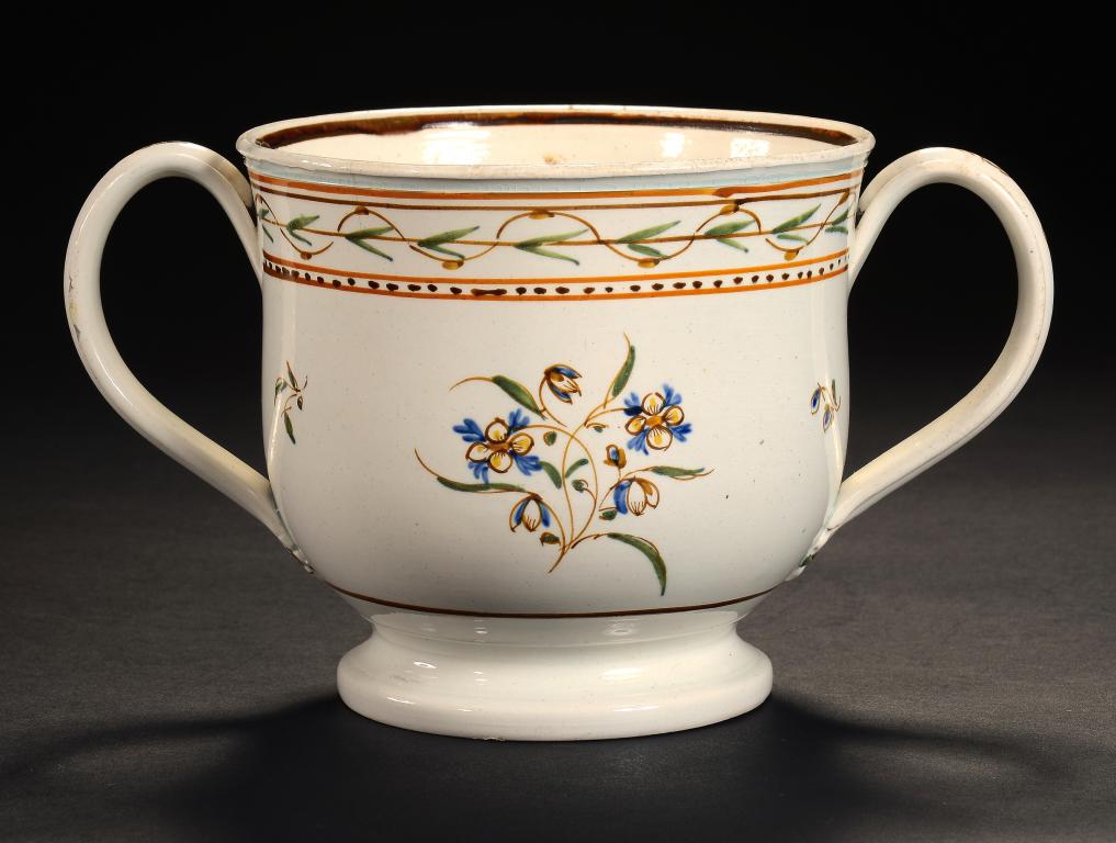 A PRATT WARE LOVING CUP, C1820 painted to either side with stylised flowers, 11.5cm h ++In fine