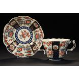A WORCESTER CHOCOLATE CUP AND SAUCER, C1770-72 with reticulated handles and decorated with a rich