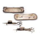 A PAIR OF CLOSE PLATED MECHANICAL WICK TRIMMERS, C1820 with spring operated blade, 17.5cm l, another