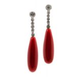 A PAIR OF DIAMOND AND CORAL EARRINGS with an articulated line of diamond collets and larger coral