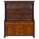 A GEORGE III OAK AND LINE INLAID DRESSER, NORTH WALES, FIRST HALF 19TH C with boarded rack, fitted