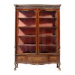 A PARCEL GILT MAHOGANY SERPENTINE CABINET BY WARINGS, C1930 the glazed doors and drawer surrounds in