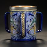 A DOULTON WARE PATE SUR PATE LOVING CUP, C1890 decorated by Emily E Stormer with panels of