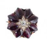 A VICTORIAN DIAMOND AND FOILED GARNET BROOCH, LATE 19TH C with larger central old cut cushion shaped