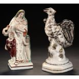 A STAFFORDSHIRE PEARLWARE GROUP OF CHARITY AND A STAFFORDSHIRE EARTHENWARE MODEL OF AN EAGLE,
