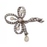 A BELLE EPOQUE DIAMOND AND CULTURED PEARL BOW BROOCH, C1900 the larger pear shaped cultured pearl en