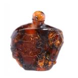 A CHINESE AMBER SNUFF BOTTLE carved with bats, peaches and cloud scrolls, stopper, 5.2cm h, engraved