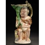 A RALPH WOOD EARTHENWARE BACCHUS AND PAN JUG TRADITIONALLY ASCRIBED TO RALPH WOOD AND MODELLED BY