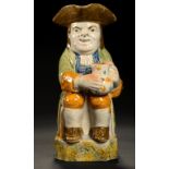 A STAFFORDSHIRE PRATTWARE TOBY JUG, EARLY 19TH C with sponged decoration to handle and base, beneath