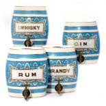 A SET OF FOUR VICTORIAN BLUE AND GILT EARTHENWARE SPIRIT BARRELS - BRANDY, GIN, I WHISKY AND RUM,