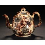 A STAFFORDSHIRE TORTOISESHELL GLAZED CREAMWARE TEAPOT AND COVER, C1760 with crabstock handle and