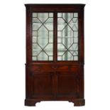 A GEORGE III MAHOGANY CORNER CUPBOARD, C1780 fitted with a central drawer, 207cm h; 55 x 125cm