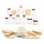 NINE GEORGE V SILVER AND IVORY MOUNTED GLASS SCENT BOTTLES AND JARS FROM A DRESSING SET AND