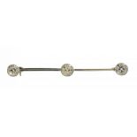 A DIAMOND BAR BROOCH, EARLY 20TH C with collet set round or cushion shaped old cut diamonds, in