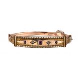 A RUBY AND DIAMOND BRACELET, 1908 in 9ct gold, gypsy set, by Henry Pope of Birmingham, Chester