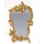 A FRENCH ORMOLU EASEL MIRROR the asymmetric openwork rococo frame with a small dragon, 44cm h ++