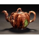 A STAFFORDSHIRE TORTOISESHELL GLAZED CREAMWARE GLOBULAR TEAPOT AND COVER, C1760 with crabstock,