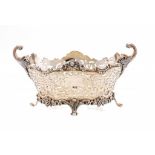 A VICTORIAN PIERCED SILVER FRUIT BOWL with flying scroll handles, 19cm w, by The Goldsmiths &