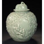 A CHINESE CELADON WINE JAR AND COVER moulded with four panels of figures beneath a border of ruyi,