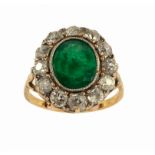 AN EMERALD AND DIAMOND CLUSTER RING in gold, marked 18ct, 4.7g, size I ++Emerald with surface chip