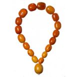 A NECKLACE OF 18 AMBER BEADS 96.6g ++Two beads chipped