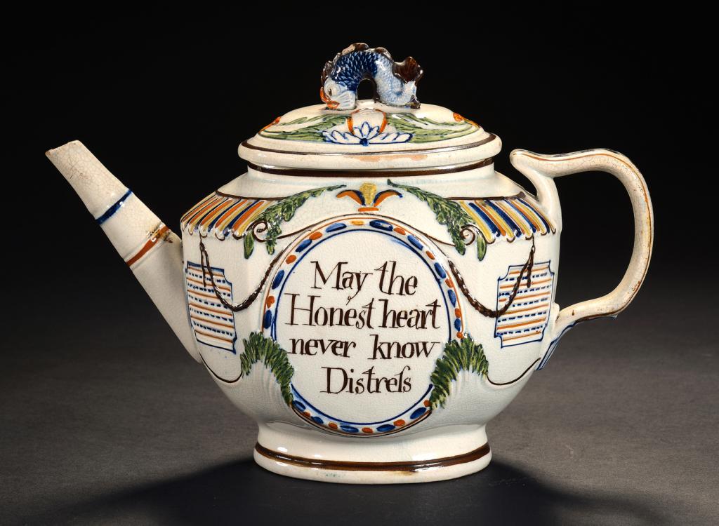 A PEARLWARE MOULDED TEAPOT AND COVER, C1805 one side inscribed in an oval frame May the Honest heart