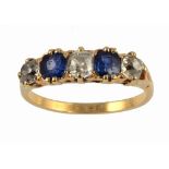 A SAPPHIRE AND DIAMOND RING with cushion shaped sapphires and old cut diamonds in gold, marked 18ct,