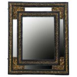 A DUTCH OR FLEMISH EMBOSSED BRASS MOUNTED AND EBONISED, RIPPLE MOULDED MIRROR, LATE 19TH C the